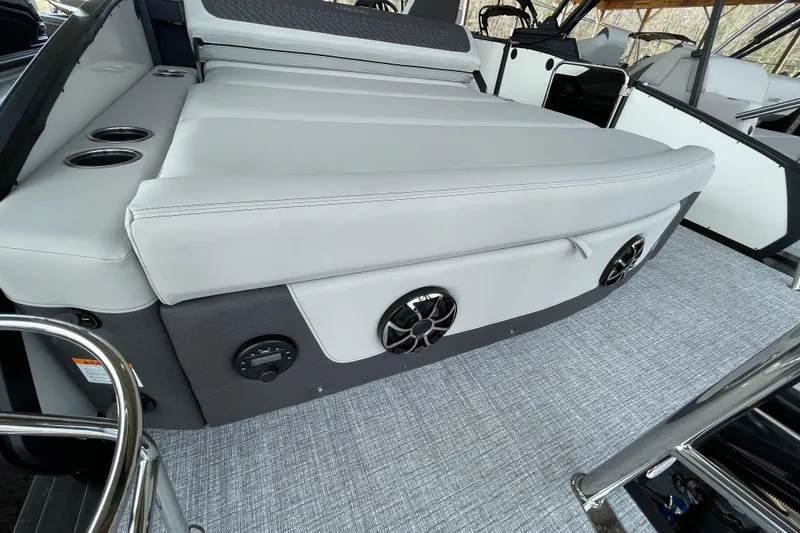 Slide: The Image of 2026 Harris Sunliner 230 boat interior with cushioned seating and built-in speakers. - 17
