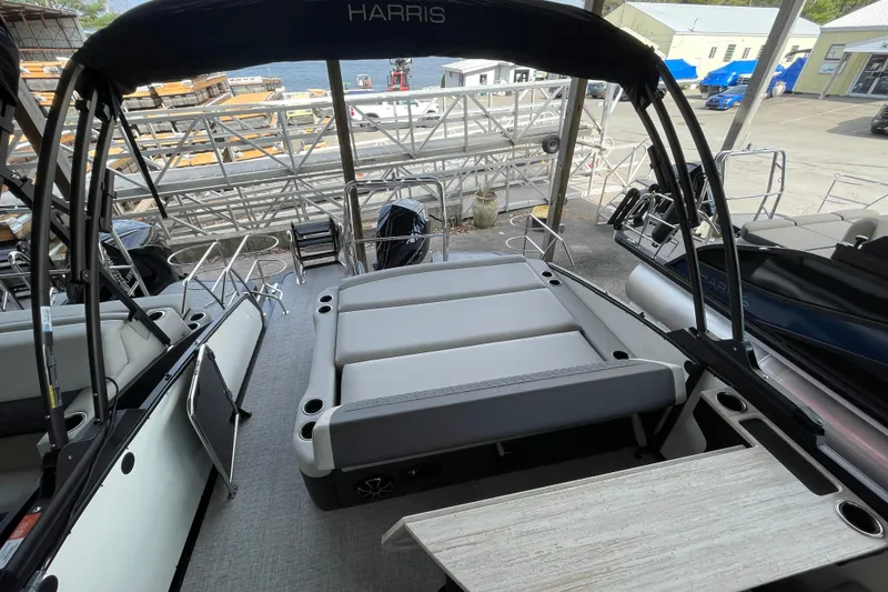Slide: The Image of 2026 Harris Sunliner 230 pontoon boat interior with seating and deck view. - 18
