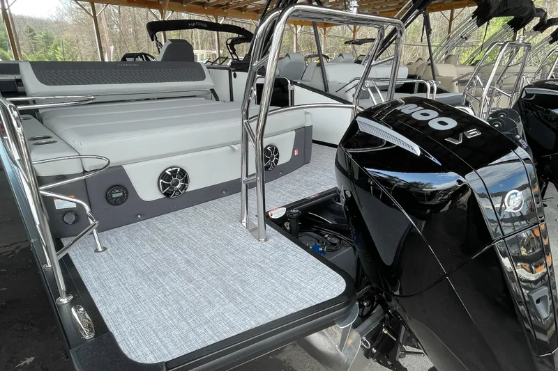 Slide: The Image of 2026 Harris Sunliner 230 boat with sleek design and powerful outboard motor. - 20