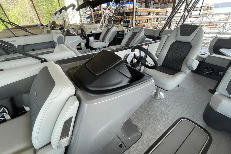 Slide: The Image of Interior of 2026 Harris Sunliner 230 pontoon boat with modern seating and steering console. - 6
