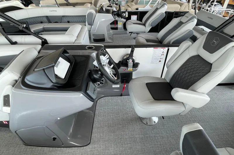 Slide: The Image of 2026 Harris Sunliner 230 boat interior with modern helm and luxurious seating. - 7
