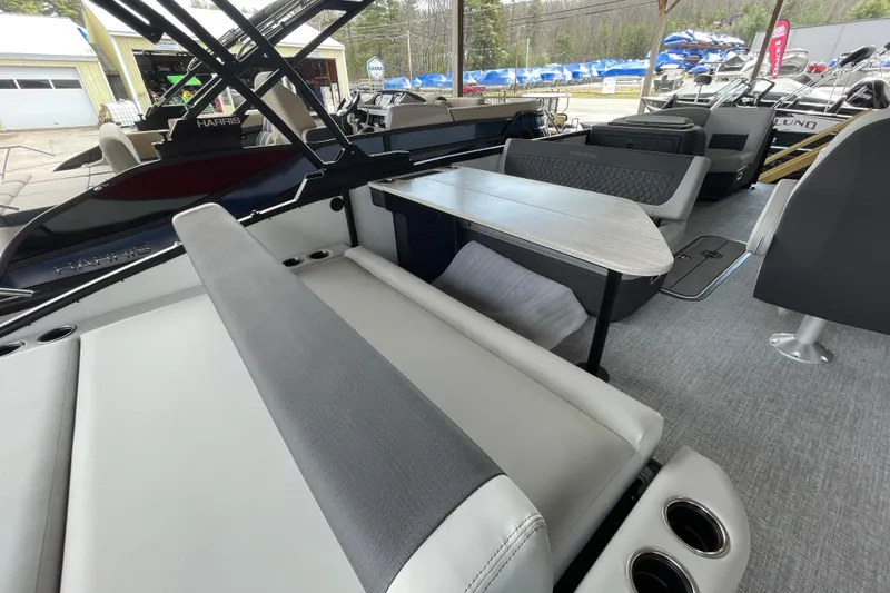Slide: The Image of 2026 Harris Sunliner 230 boat interior with seating and table, showcasing modern design. - 9