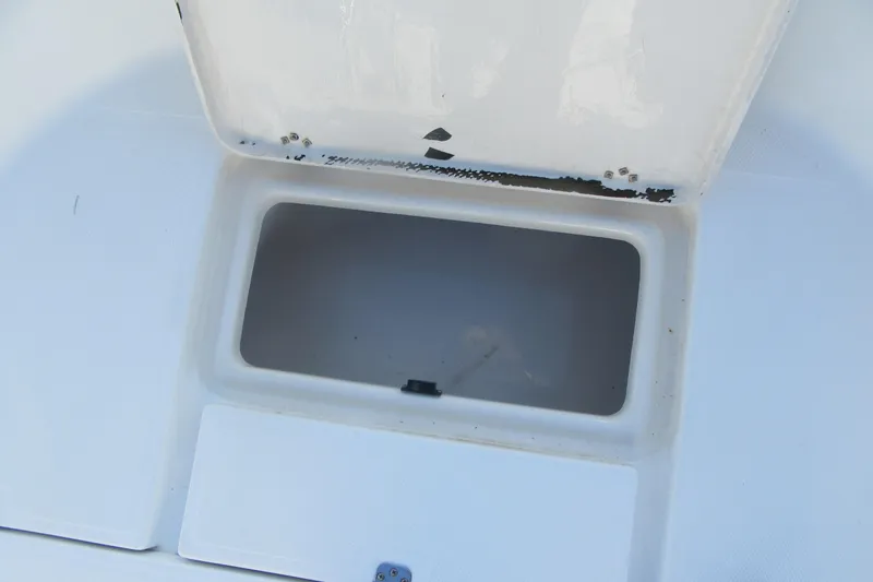 Slide: The Image of Open storage compartment on a 2000 Sport-Craft 24 CC boat. - 10