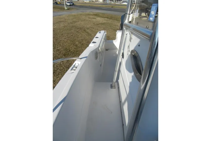 Slide: The Image of 2000 Sport-Craft 24 CC boat deck, featuring clean white surfaces and stainless steel railings. - 12