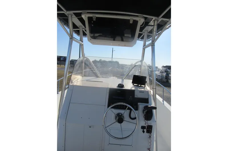 Slide: The Image of 2000 Sport-Craft 24 CC boat cockpit with steering wheel and navigation equipment. - 14