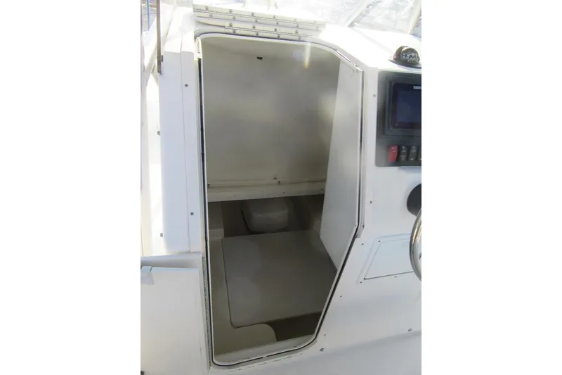 Slide: The Image of 2000 Sport-Craft 24 CC boat cabin interior with control panel and seating area. - 15
