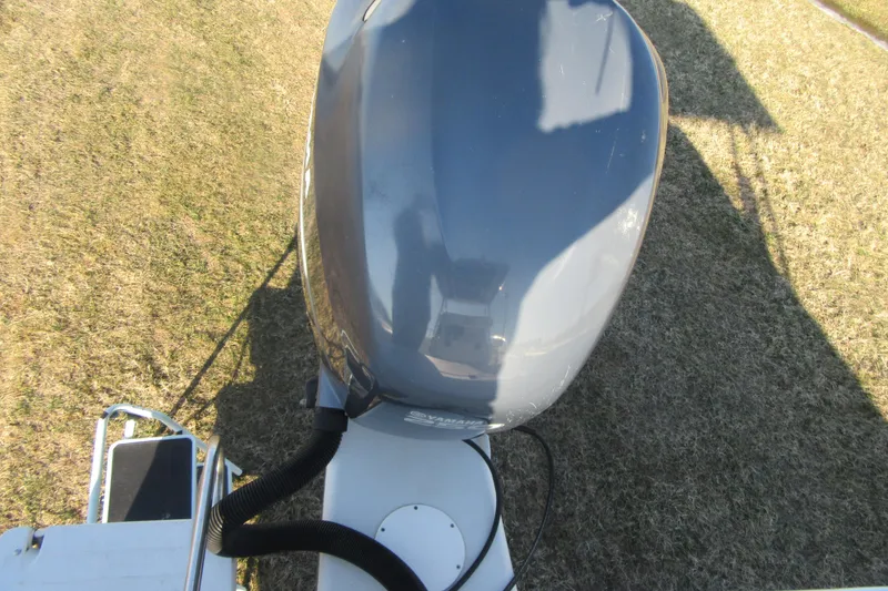 Slide: The Image of Outboard motor on 2000 Sport-Craft 24 CC boat, viewed from above on grass. - 23