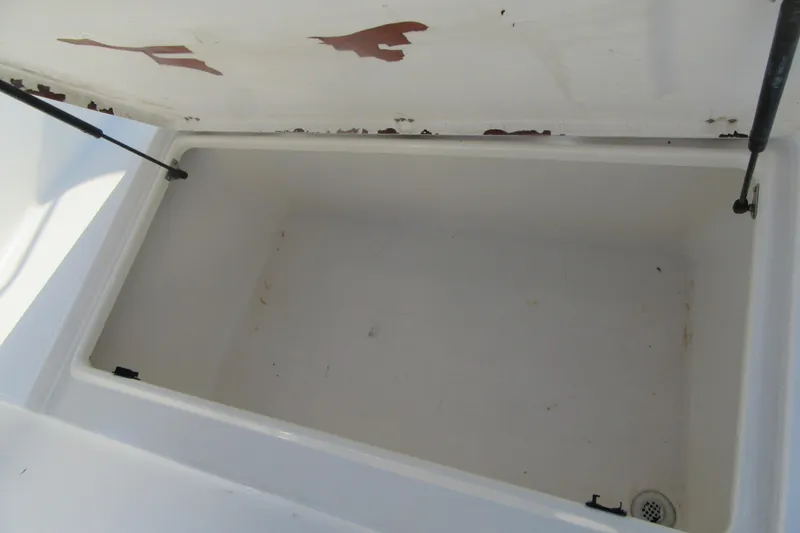 Slide: The Image of Open storage compartment on 2000 Sport-Craft 24 CC boat, showing interior details. - 9