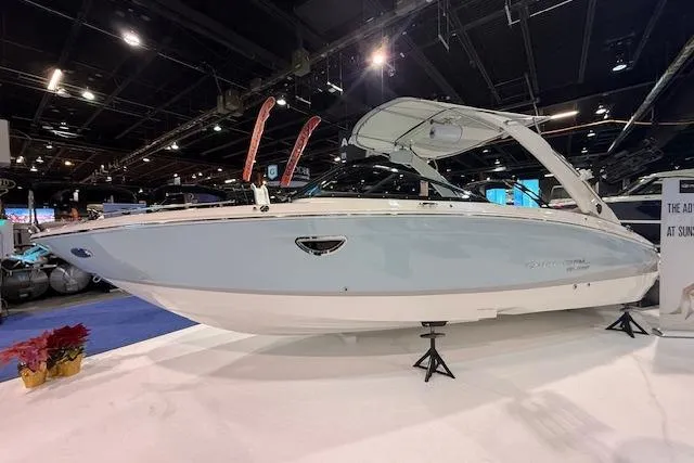 The Image of 2026 Regal LS6 Surf boat displayed indoors on stands. - 0