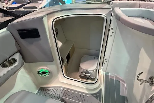 Slide: The Image of 2026 Regal LS6 Surf boat interior with compact restroom and modern amenities. - 10