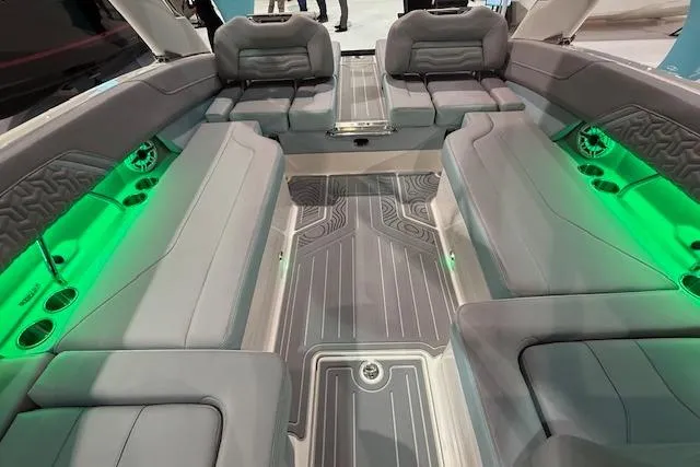 Slide: The Image of 2026 Regal LS6 Surf boat interior with gray seating and green LED lighting. - 16
