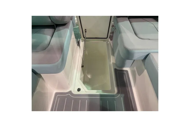 Slide: The Image of 2026 Regal LS6 Surf boat interior with open storage compartment and cushioned seating. - 19