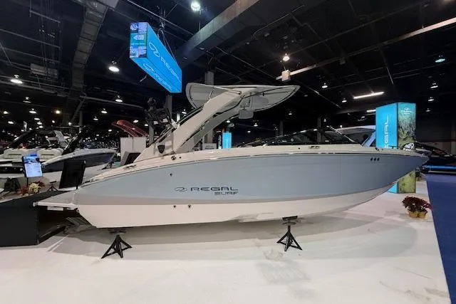 Slide: The Image of 2026 Regal LS6 Surf boat displayed at an indoor exhibition. - 2