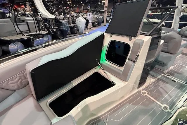 Slide: The Image of 2026 Regal LS6 Surf boat interior with open storage compartments at a boat show. - 21