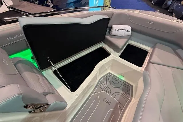 Slide: The Image of 2026 Regal LS6 Surf boat interior with sleek seating and storage compartments. - 22