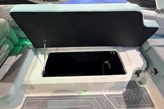Slide: The Image of 2026 Regal LS6 Surf boat storage compartment open, showcasing interior space. - 25