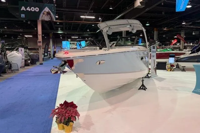 Slide: The Image of 2026 Regal LS6 Surf boat displayed at an indoor exhibition with blue carpet. - 3
