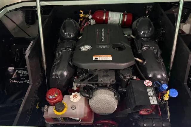 Slide: The Image of Engine compartment of 2026 Regal LS6 Surf boat, featuring modern components and fire extinguisher. - 31