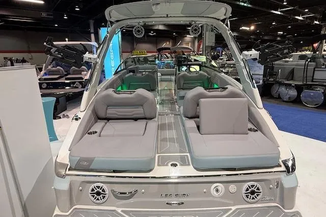Slide: The Image of 2026 Regal LS6 Surf boat interior with luxurious seating and modern design at a boat show. - 4