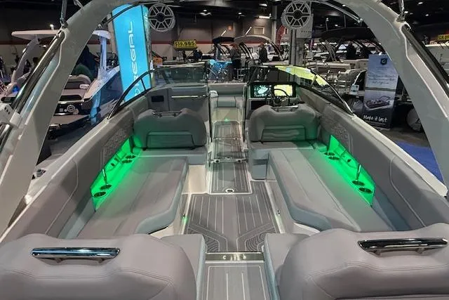Slide: The Image of 2026 Regal LS6 Surf boat interior with green LED lighting at a boat show. - 5