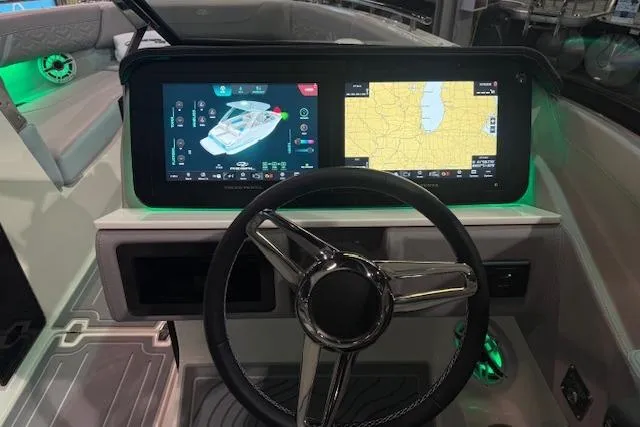 Slide: The Image of 2026 Regal LS6 Surf boat dashboard with dual digital displays and steering wheel. - 7