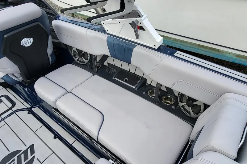 Slide: The Image of 2021 Malibu Wakesetter 23 MXZ interior with plush seating and built-in speakers. - 11