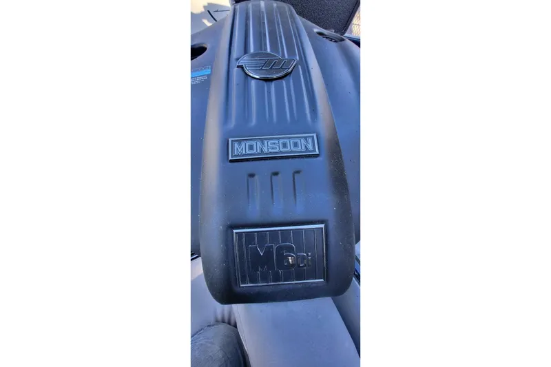 Slide: The Image of 2021 Malibu Wakesetter 23 MXZ Monsoon engine cover, showcasing MG6.2L branding. - 14