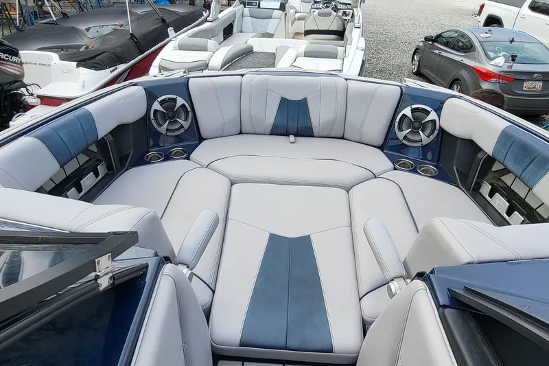 Slide: The Image of 2021 Malibu Wakesetter 23 MXZ boat interior with plush seating and speakers. - 16