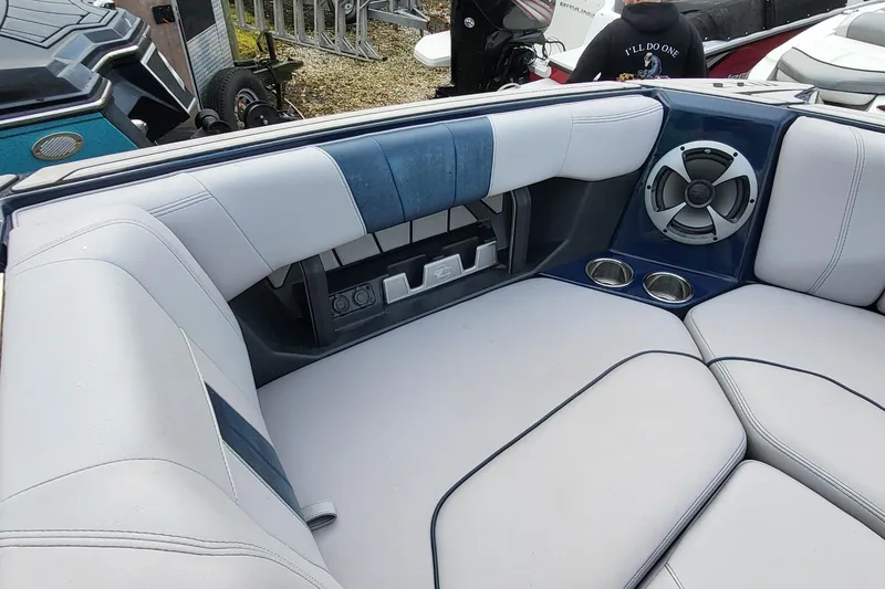 Slide: The Image of 2021 Malibu Wakesetter 23 MXZ interior with cushioned seating and speaker system. - 18