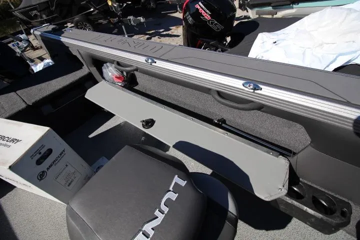 Slide: The Image of 2026 Lund 2275 Baron boat interior with storage compartments and Mercury engine. - 12