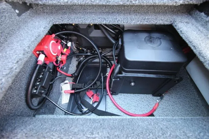Slide: The Image of 2026 Lund 2275 Baron boat battery compartment with wiring and connections. - 14
