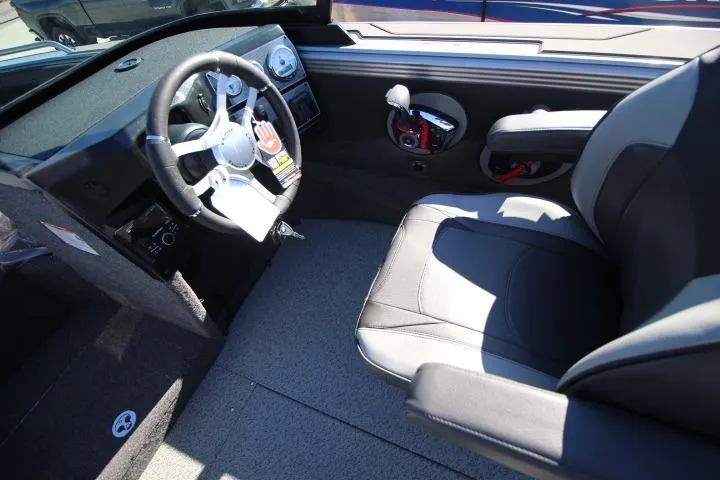 Slide: The Image of 2026 Lund 2275 Baron boat interior with steering wheel and seating. - 2