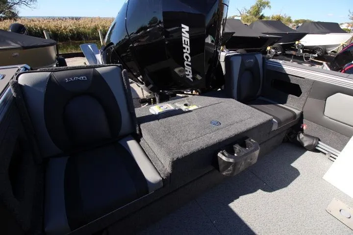 Slide: The Image of 2026 Lund 2275 Baron boat interior with Mercury engine, featuring comfortable seating and modern design. - 21