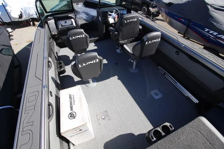 Slide: The Image of 2026 Lund 2275 Baron boat interior with seating and Mercury box on deck. - 23