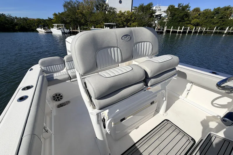 Slide: The Image of 2018 Sea Fox 248 Commander boat interior with cushioned seating and water view. - 10