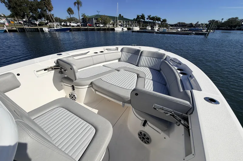 Slide: The Image of 2018 Sea Fox 248 Commander boat with spacious seating, docked by a scenic waterfront. - 13