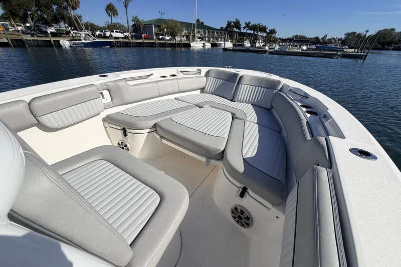 Slide: The Image of 2018 Sea Fox 248 Commander boat with spacious seating, docked by a marina. - 15