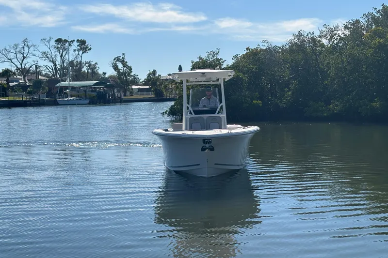 Slide: The Image of 2018 Sea Fox 248 Commander boat cruising on a calm river under a clear sky. - 3