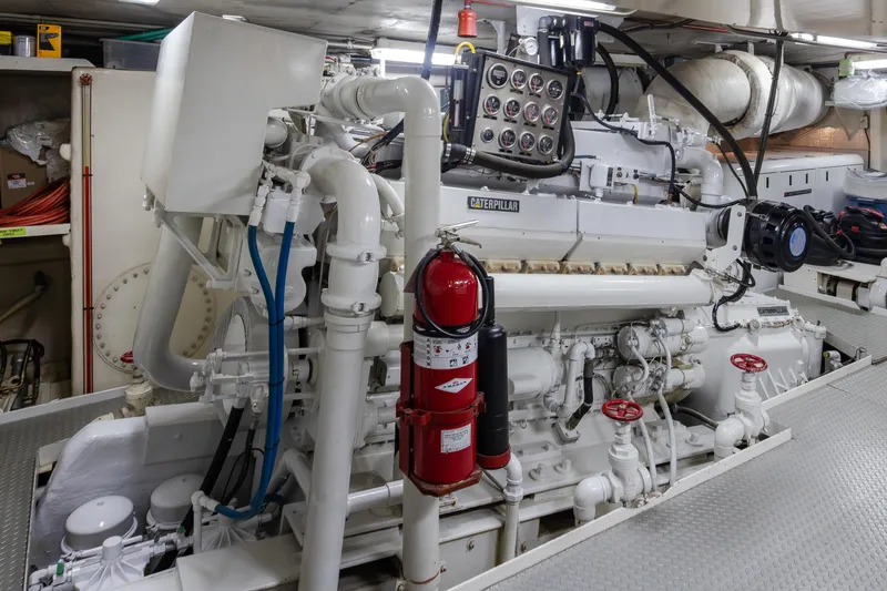 Slide: The Image of Engine room of a 1974 Willard 1201 with Caterpillar machinery and fire extinguisher. - 21