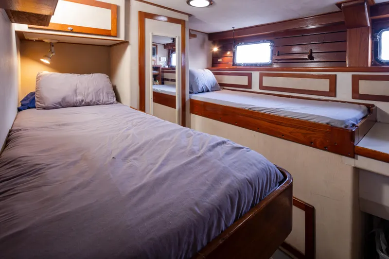 Slide: The Image of Cozy cabin interior of 1974 Willard 1201 with twin beds and wooden accents. - 22