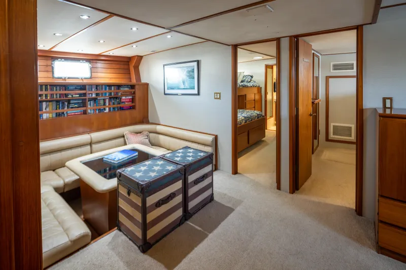 Slide: The Image of Luxurious 1974 Willard 1201 yacht interior with cozy seating, bookshelves, and stylish decor. - 26