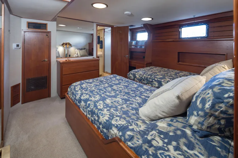 Slide: The Image of 1974 Willard 1201 yacht cabin with twin beds, wooden interior, and nautical decor. - 30
