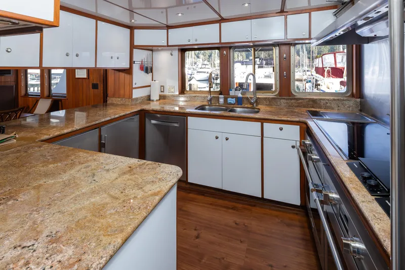 Slide: The Image of Luxurious 1974 Willard 1201 yacht kitchen with granite countertops and modern appliances. - 39