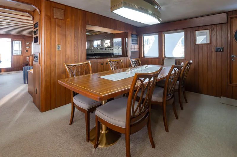 Slide: The Image of Elegant dining area on 1974 Willard 1201 yacht with wooden interior and large windows. - 41