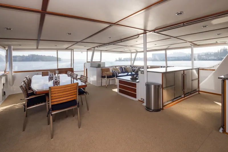Slide: The Image of Luxurious interior of 1974 Willard 1201 yacht with dining area and scenic water views. - 50