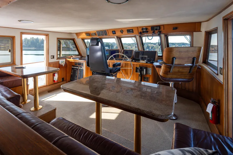 Slide: The Image of Interior of a 1974 Willard 1201 boat with wooden helm and seating area. - 56