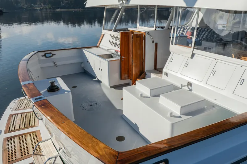 Slide: The Image of 1974 Willard 1201 boat deck with wooden trim and storage compartments. - 7