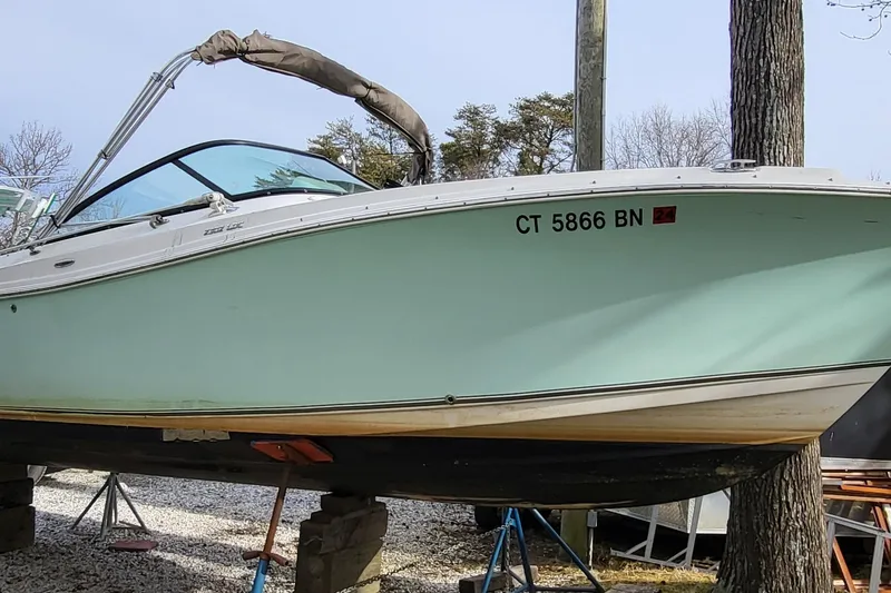 The Image of 2018 NauticStar 2302 Legacy boat on stands, light blue hull, winter setting. - 0