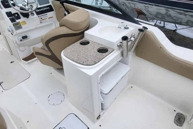 Slide: The Image of 2018 NauticStar 2302 Legacy boat interior with helm, seating, and storage features. - 13