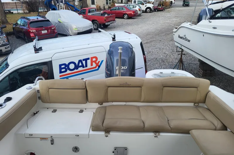 Slide: The Image of 2018 NauticStar 2302 Legacy boat dashboard with steering wheel and controls. - 4